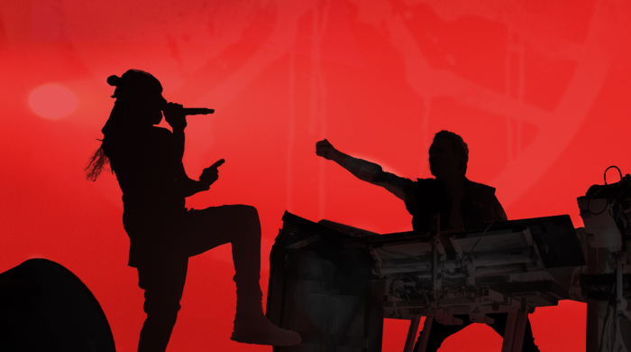 The Prodigy standing in front of red background